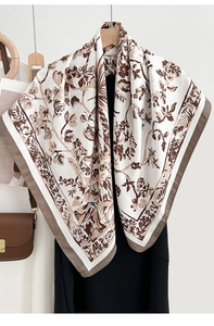Detail of vintage floral print scarf draped over a black dress showing soft silk texture