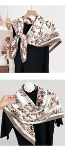 Detailed close-up of French vintage floral silk scarf with elegant botanical print patterns