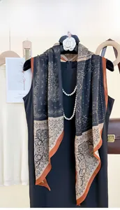 Detail of vintage navy and caramel paisley floral print scarf on elegant black dress