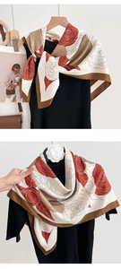 Detail of red and cream floral silk scarf featuring elegant vintage camellia print texture