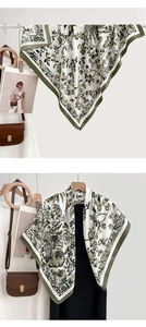 Detail of elegant olive green floral print on cream square silk scarf with contrast border
