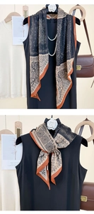 Detail of vintage paisley silk scarf featuring black and caramel geometric patterns