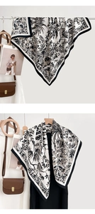Close-up of silk scarf with vintage botanical flower prints and striped borders