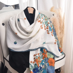 Elegant floral print shawl for women featuring orange and blue patterns on white fabric