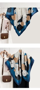 Detail of elegant silk square scarf with blue borders and brown rose floral prints
