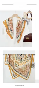 Detail of paisley pattern imitation cashmere scarf in orange and cream tones