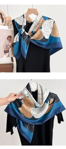 Detail of floral silk scarf showing smooth satin texture and elegant color-blocking pattern