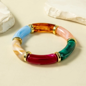 Detailed shot of multi-colored acrylic segment bracelet with golden metal spacers