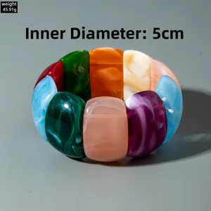 Macro shot of colorful acrylic bracelet featuring marble textures and a 5cm inner diameter