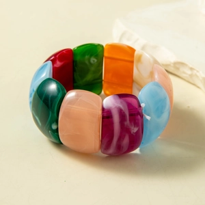 Macro view of colorful acrylic stretch bracelet with marbled textures and vibrant beads