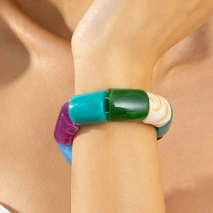 Close-up of colorful acrylic beaded elastic bracelet with marble texture worn on wrist