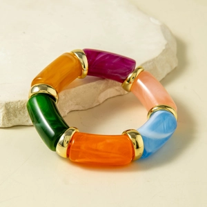 Detail of colorful resin beaded bracelet with gold spacers and marble texture