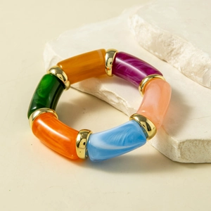 Macro detail of colorful marble-textured resin beads with gold metal ring accents