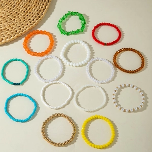 Flat lay of colorful seed bead bracelets set with acrylic and faceted glass crystals