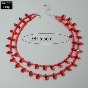 Macro detail of red beaded choker with marquise crystal pendants and lobster clasp
