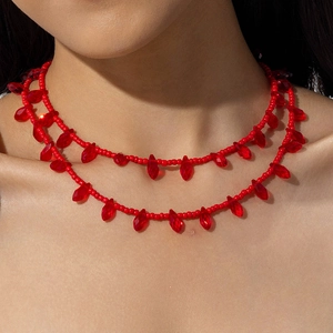 Gothic style red double-layer beaded necklace with faceted crystal charms on a model