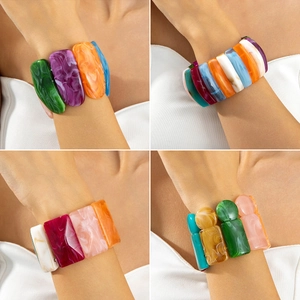 Colorful chunky acrylic stretch bracelets with marble texture on a female model