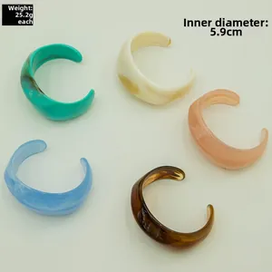 Detailed top view of five acrylic open cuffs showing interior diameter and light weight