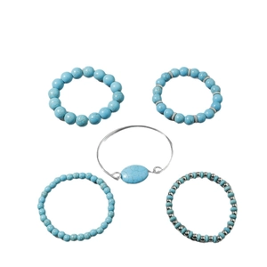 Five-piece bohemian turquoise bead bracelet set with silver accents on white background
