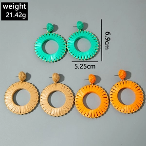 Detail view of colorful raffia woven earrings with dimensions 6.9cm by 5.25cm