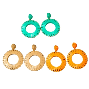 Three pairs of Bohemian raffia woven hoop earrings in green, beige and orange colors