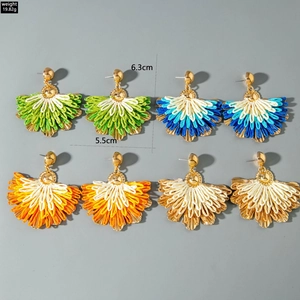 Detail view of colorful raffia fan-shaped tassel earrings with size and weight specs