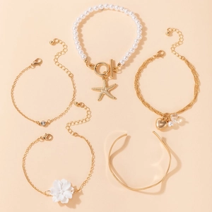 Five-piece gold bracelet set featuring camellia flower, pearls and starfish charms