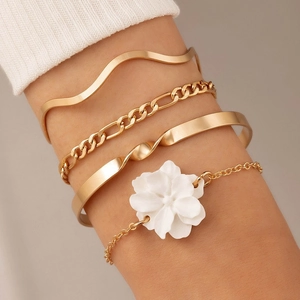 Detail of 4pcs gold bracelet set with white camellia charm and layered chain designs