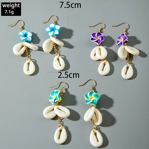 Detail view of colorful flower earrings with white shells and gold hooks, 7.5cm length