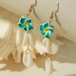 Close-up of tropical plumeria earrings with turquoise flowers and natural shell drops