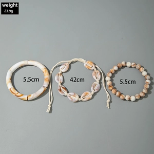 Detail view of bohemian 3-piece jewelry set with marble resin, shell and bead accents