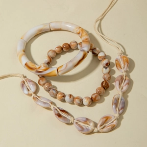 Bohemian jewelry set featuring marble resin bangles and woven natural shell necklace