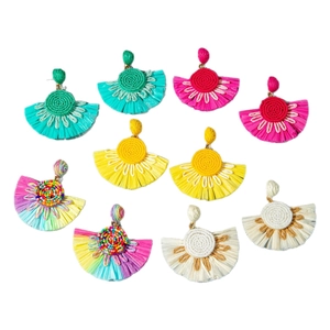 Five pairs of fan-shaped raffia tassel earrings in various vibrant bohemian colors