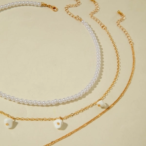 Elegant multi-layered gold necklaces with white pearls and starfish shell pendants