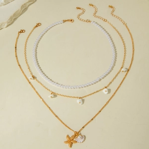 Three-layered gold starfish and shell pendant necklace set with elegant white pearls