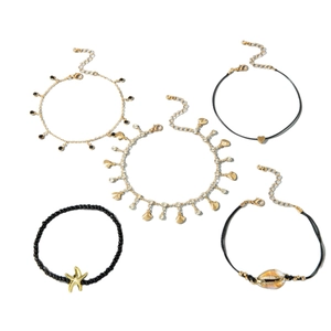Five-piece bohemian anklet set featuring starfish, shells, beads, and rhinestones in gold