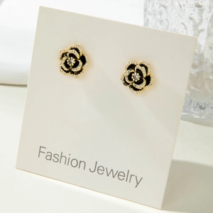 Elegant black camellia flower earrings with gold plating and sparkling crystals