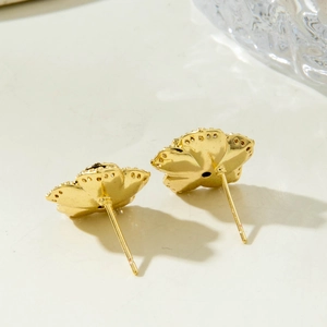 Elegant gold flower stud earrings with detailed back texture and minimalist design