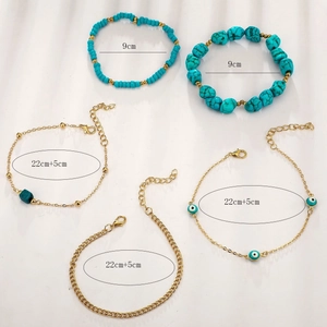 Bohemian multi-layer anklet set with turquoise beads and evil eye charms on white background