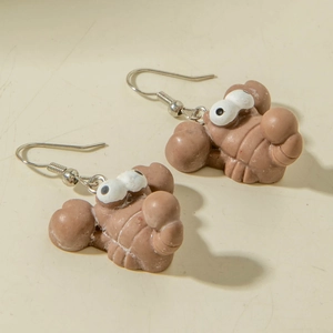 Detail of creative cartoon lobster earrings featuring large eyes and silver hooks