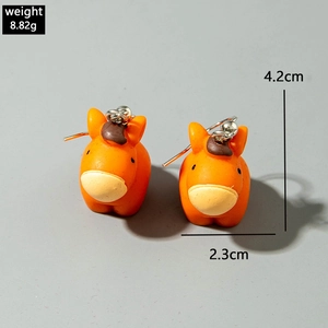 Detailed view of 3D cartoon orange pony earrings with silver hooks and size measurements