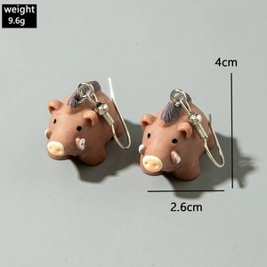 Detailed view of wild boar earrings showing resin texture, tusks, and 4cm size dimensions