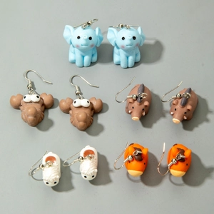 Detail of five pairs of 3D cartoon animal earrings featuring elephants and horses