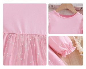 Detail of pink long sleeve girl's dress with star sequins and tulle skirt mesh