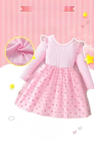 Close-up of pink long sleeve dress showing soft ribbed fabric and polka dot tulle skirt