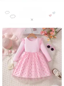 Detail of pink long-sleeve dress with ribbed knit bodice and polka dot tulle skirt
