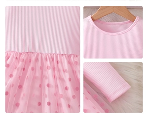 Detailed view of pink ribbed knit bodice and polka dot tulle skirt stitching