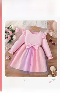 Detail of girls' dress featuring pink ribbed knit bodice and sequined rainbow tulle skirt