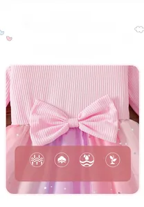 Detail of pink cotton dress featuring a large bow and star-patterned layered tulle skirt