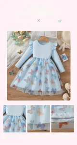 Detail of girls' light blue dress featuring layered mesh skirt with colorful butterfly prints